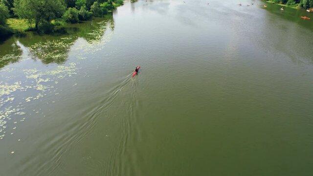 People Kayaking on River. Center for Sports Training in Kayaking and Canoeing. 4k aerial footage. Flyout three kayaks on river at summer.