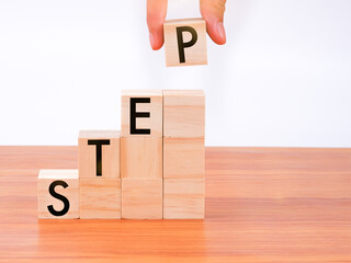 Hand putting wooden blocks with alphabet 