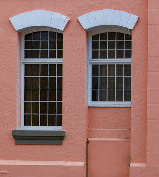 vintage metal windows on colorful wall of the house in old city.