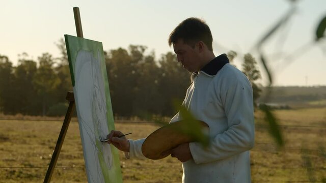 Artist painting a horse on a canvas, in the field