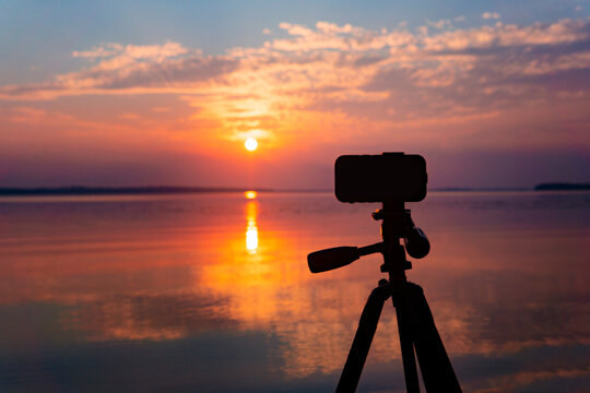 Smart Phone Photography Concept Camera Phone On Tripod At Colorful Sunset