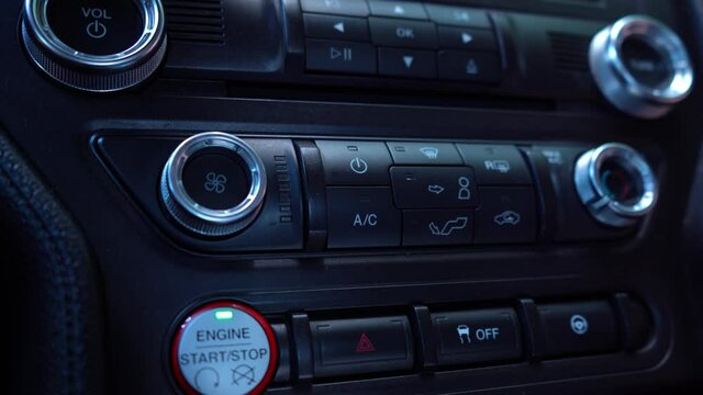 Turning on internal recirculation in a car. A mans hand presses the button in the car. 4K video footage.