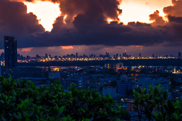 The high angle background of the city view with the secret light of the evening, blurring of night lights, showing the distribution of condominiums, dense homes in the capital community