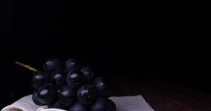 Tilt-down image of grapes on black background.