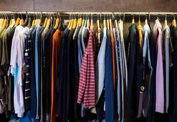 Assortment of summer and autumn clothing in modern garment store interior