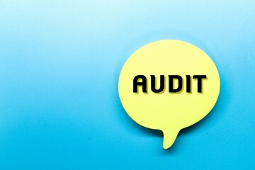 yellow paper forms a conversation bubble with the word audit