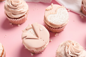 Tasty wedding cupcakes on color background
