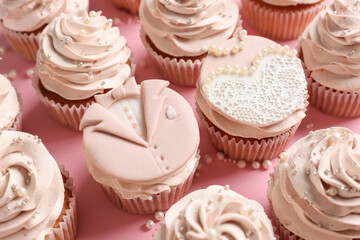 Tasty wedding cupcakes on color background
