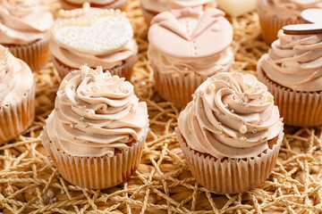 Tasty wedding cupcakes on wicker mat