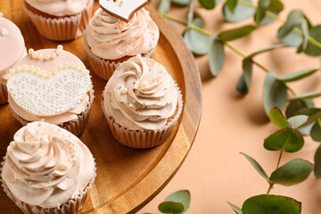 Dessert stand with tasty wedding cupcakes on color background, closeup