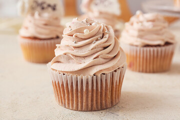 Tasty wedding cupcake on table
