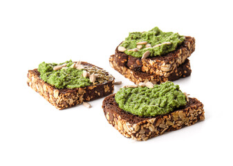 Tasty toasts with pesto sauce and seeds on white background