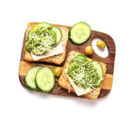 Tasty toasts with pesto sauce, cucumber and olives on white background