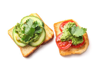 Tasty toasts with pesto sauce on white background
