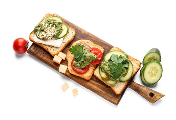 Tasty toasts with pesto sauce on white background