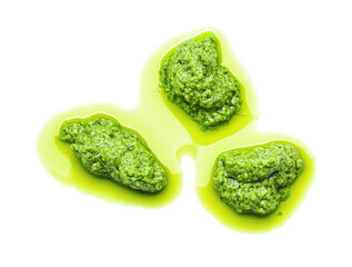 Smears of tasty pesto sauce on white background