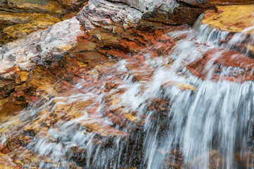 Water flowing over brown rocks