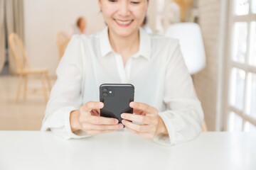 woman work using cell phone hand holding mobile texting message contact us.chatting,search internet...