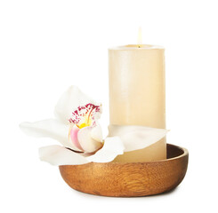 Bamboo tray with burning candle and orchid flower on white background