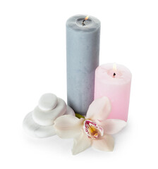 Composition with burning candles, spa stones and orchid flower on white background