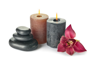 Composition with burning candles, spa stones and orchid flower on white background