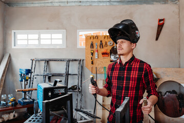 carpenter welding in his carpentry