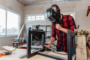carpenter welding in his carpentry