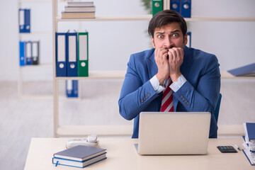 Young male employee working in the office