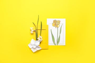 Narcissus flowers and greeting card on color background