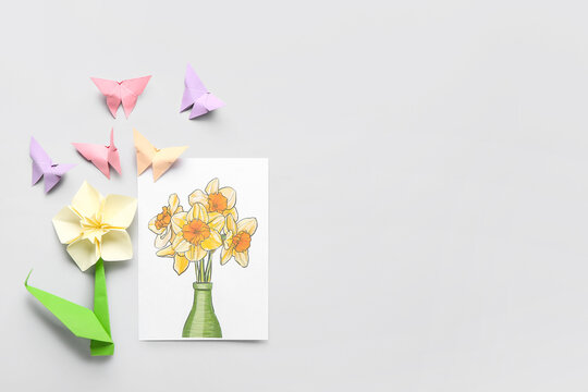 Greeting card, origami narcissus flower and butterflies on light background