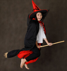 Cheerful witch flying on broom
