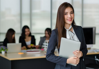Portrait of young attractive Asian female office worker in formal business suits  smiling at camera...