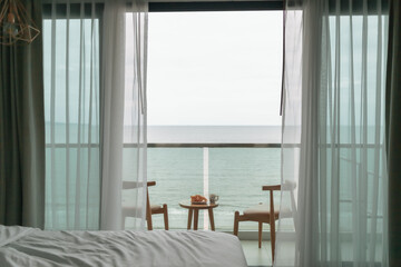 Table and chairs on the balcony with sea view. Summer travel concept.