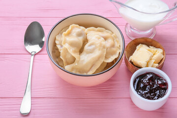 Composition with tasty cherry dumplings on color wooden background