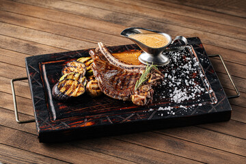 Top view on grilled beef steak with vegetables and pepper sauce