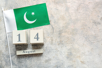 Flag of Pakistan and calendar with date of Independence Day on grunge background