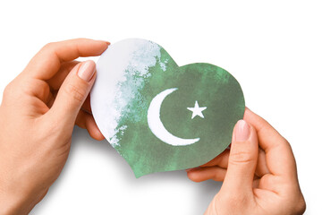 Female hands with flag of Pakistan in shape of heart on white background
