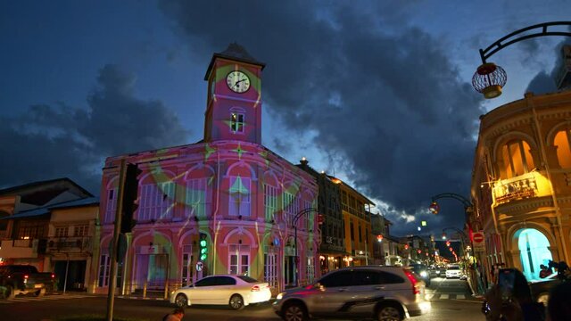 .Phuket,Thailand-July,26,2021: cloud in sunset moving above the architectural style in .Phuket city was built in Chino portuguese style one of landmarks in Phuket City..colorful light show at night.