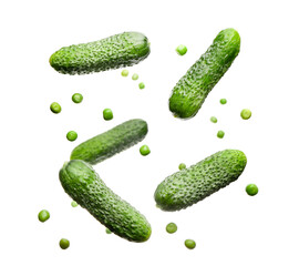 Flying green pea and cucumbers on white background