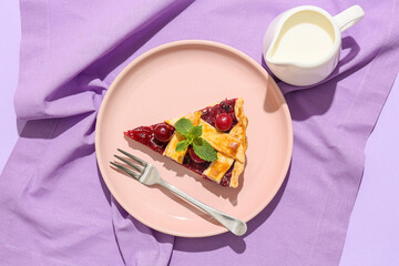 Composition with tasty cherry pie and jug of milk on color background