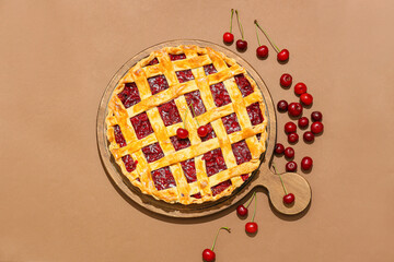 Board with tasty cherry pie on color background