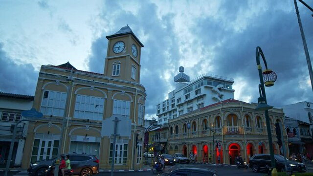Phuket,Thailand-July,26,2021: cloud in sunset moving above the architectural style in .Phuket city was built in Chino portuguese style one of landmarks in Phuket City..colorful light show at night.