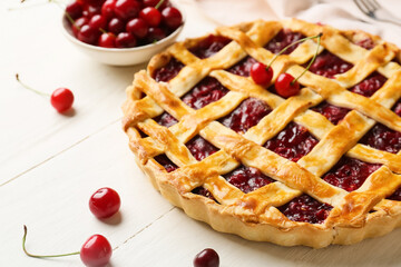 Tasty cherry pie on light wooden background, closeup