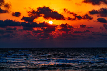 Fototapeta na wymiar Colorful dramatic sunset on the coast