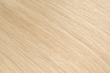 closeup texture of multiple pieces of clip in straight blonde human hair extensions