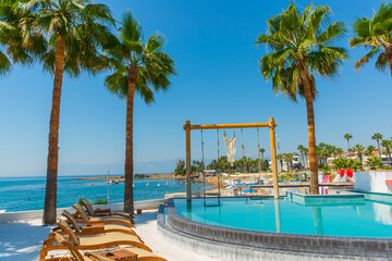 ANTALYA, TURKEY: Swimming pool and swing on the territory of Fosforlu beach on a sunny day.