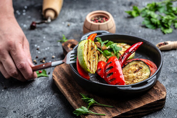 Bounty of colorful grilled vegetables served on cast iron pan. Assortment various barbecue vegan food