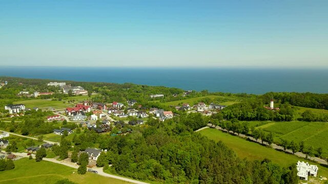 Aerial pull back revealing Jastrzebia Gora and Rozewie cities from top located near Baltic sea Poland in Summer daytime