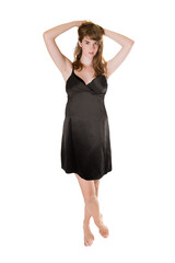 Fototapeta premium Full length portrait of a young woman wearing an elegant black evening dress, isolated in front of white studio background