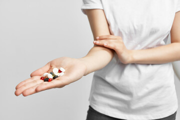 Fototapeta na wymiar woman holding pills in capsules in palm pharmacy medicine treatment